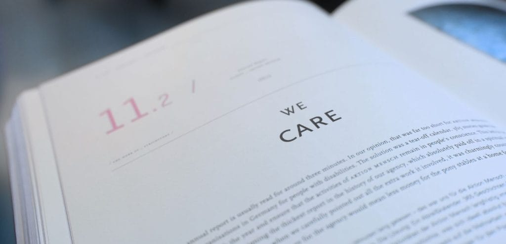 An open book turned to a chapter with the title "We Care"